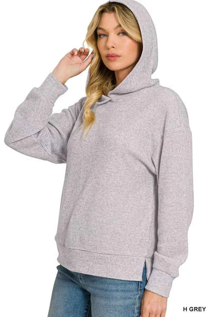 Woman wearing a Heather Grey brushed ribbed hacci knit hoodie with long sleeves and a relaxed fit by Zenana. Side View