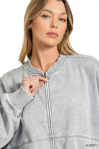 Woman wearing a Sleet acid wash fleece bomber jacket by Zenana featuring a relaxed fit, ribbed trim, zip front and soft vintage washed finish. close view