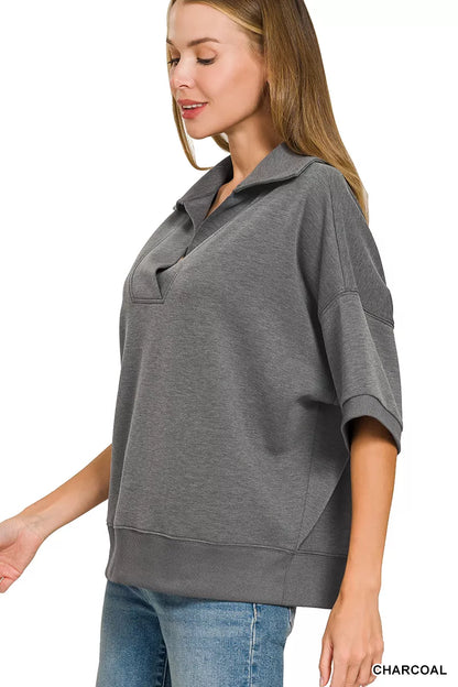 Woman wearing a Zenana charcoal scuba knit two-piece set featuring a collared short-sleeve pullover top and matching wide-leg pants with pockets.
