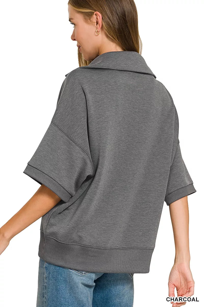 Woman wearing a Zenana charcoal scuba knit two-piece set featuring a collared short-sleeve pullover top and matching wide-leg pants with pockets.