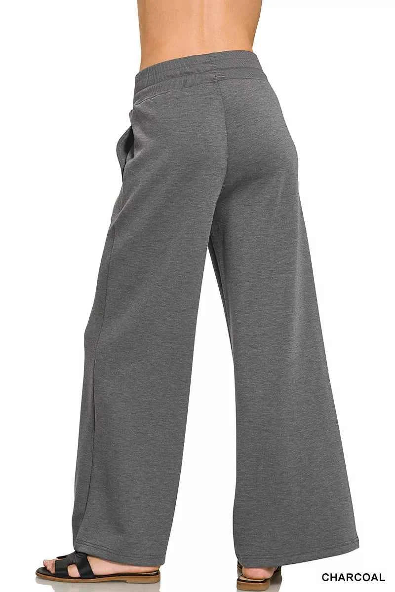 Woman wearing a Zenana charcoal scuba knit two-piece set featuring a collared short-sleeve pullover top and matching wide-leg pants with pockets. Back View