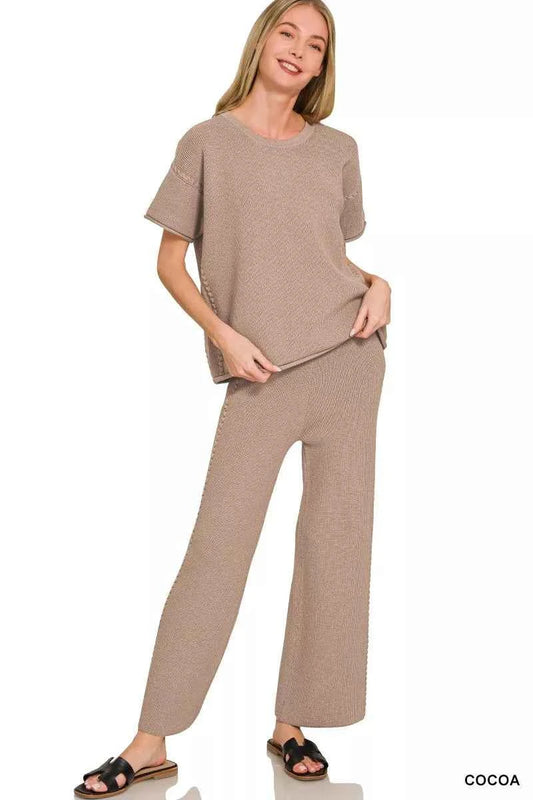 Woman wearing a Zenana cocoa ribbed knit two-piece lounge set featuring a relaxed short-sleeve top and matching wide-leg pants. Front View