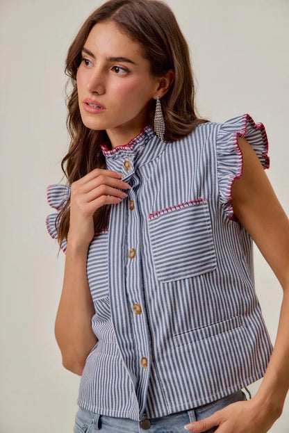 Woman wearing a blue and white striped sleeveless twill vest by SO ME featuring red whipstitch trim, ruffled collar, hidden button front and front pockets. Front view 3