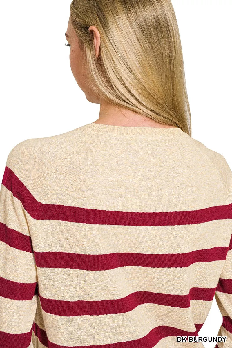 Woman wearing a burgundy striped lightweight wool blend crew neck sweater by Zenana. Back View