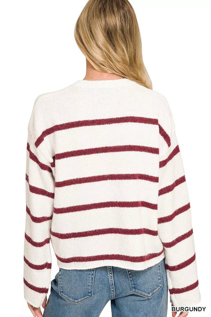 Woman wearing a burgundy striped wool blend sweater with blue jeans by Zenana. Back View