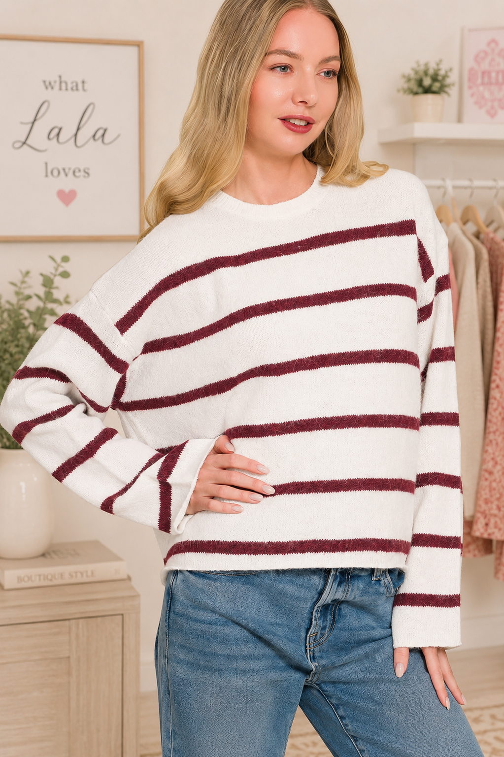 Woman wearing a burgundy striped wool blend sweater with blue jeans by Zenana. Front View