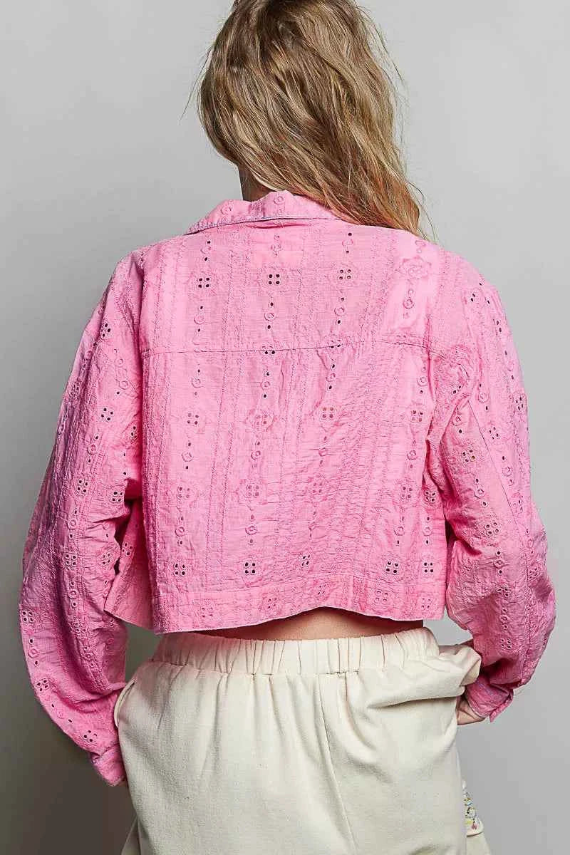 Woman wearing a candy pink eyelet cropped cotton jacket by POL, featuring textured fabric, button-front styling, and feminine boutique details. Back View