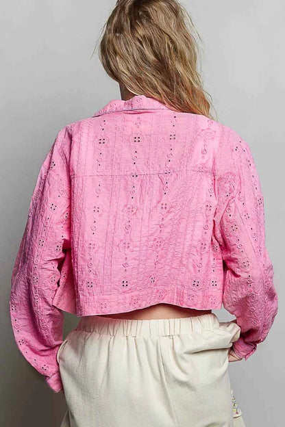 Woman wearing a candy pink eyelet cropped cotton jacket by POL, featuring textured fabric, button-front styling, and feminine boutique details. Back View