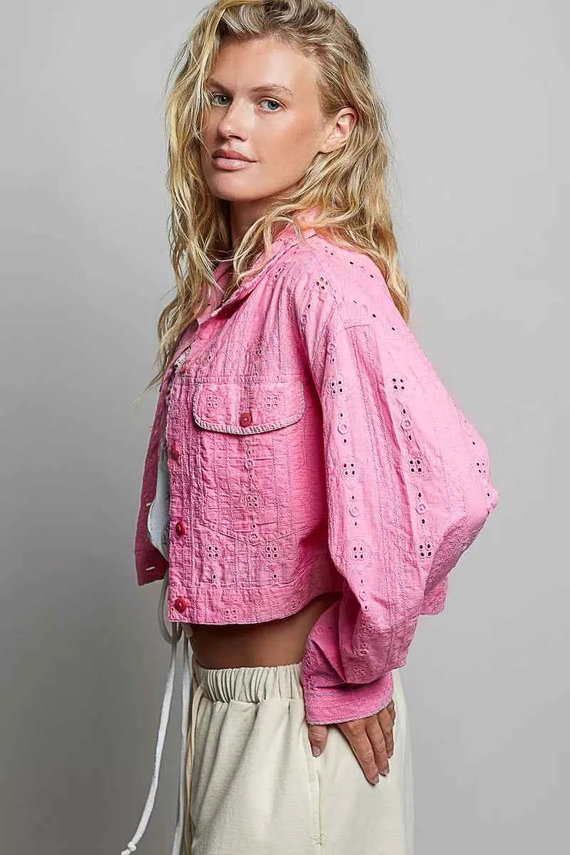 Woman wearing a candy pink eyelet cropped cotton jacket by POL, featuring textured fabric, button-front styling, and feminine boutique details. Side View