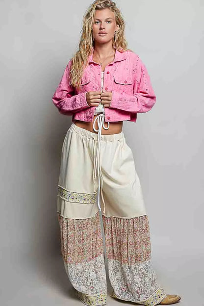 Woman wearing a candy pink eyelet cropped cotton jacket by POL, featuring textured fabric, button-front styling, and feminine boutique details. full view