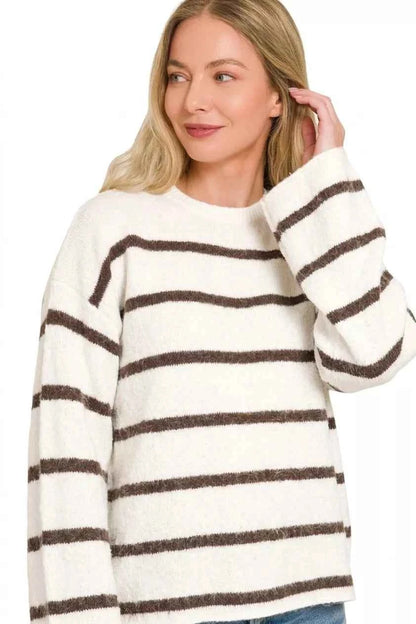 Woman wearing a cream sweater with brown horizontal stripes, long sleeves, and a relaxed fit by Zenana. Front view 2