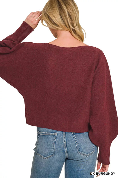 Woman wearing a dark burgundy boat neck sweater with oversized balloon sleeves, ribbed cuffs, and relaxed fit styled with blue denim jeans by Zenana. Back View