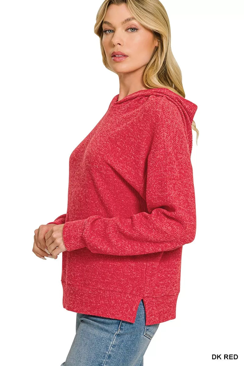 Woman wearing a dark red brushed ribbed hacci hoodie with drawstring hood styled with blue jeans by Zenana. Side View
