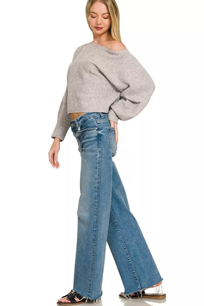 Woman wearing a heather grey boat neck balloon sleeve knit sweater by Zenana. Full Side View