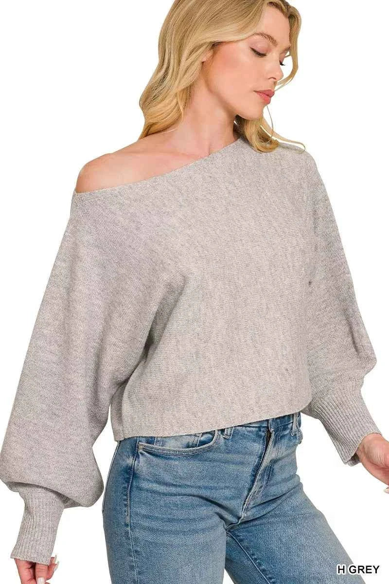 Woman wearing a heather grey boat neck balloon sleeve knit sweater by Zenana. Side View