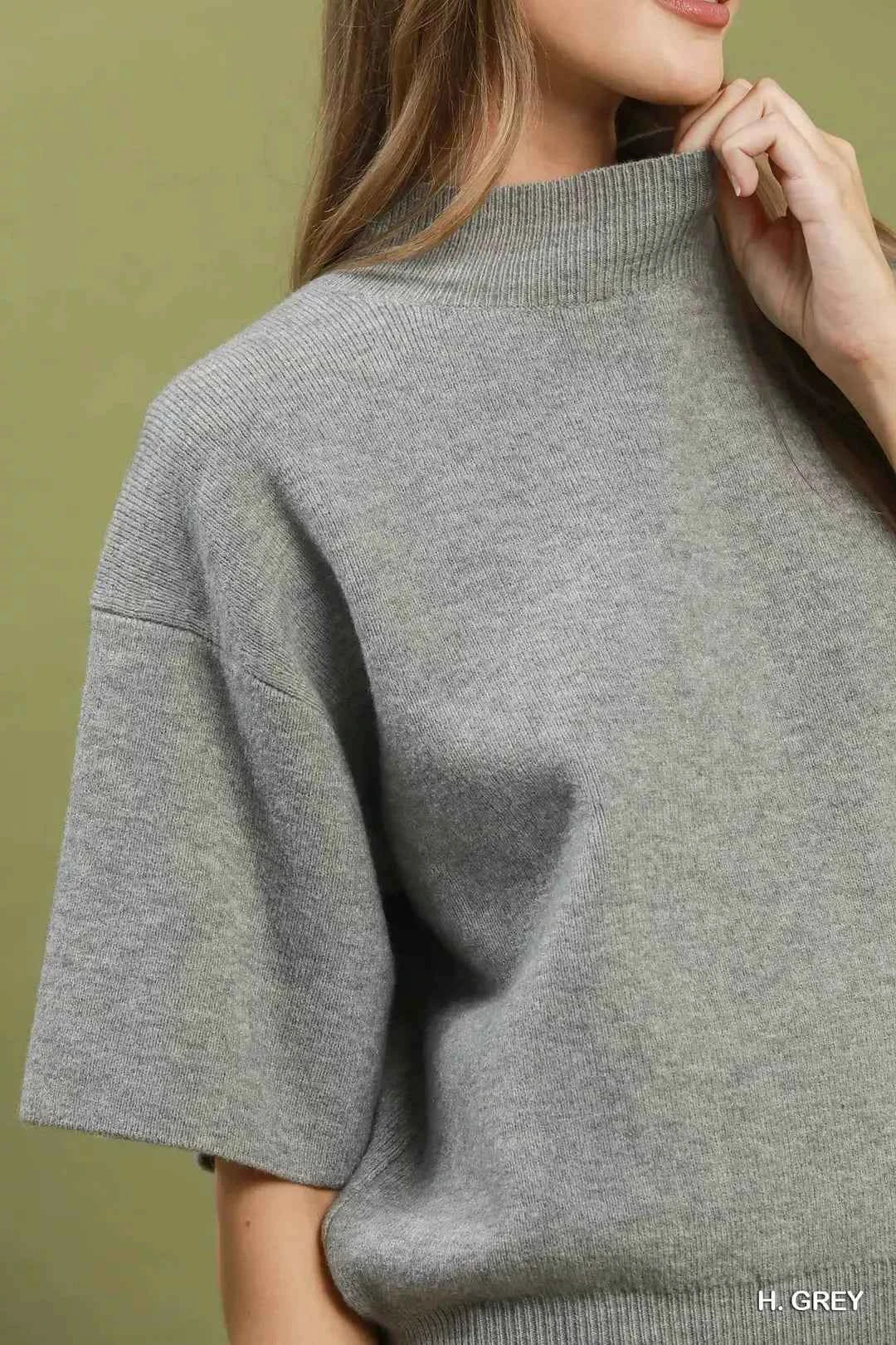 Woman wearing a heather grey mock neck short sleeve knit sweater top by Umgee. Close View