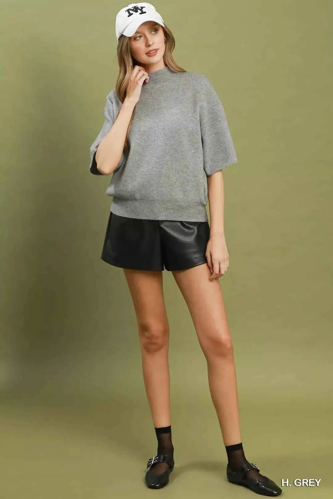 Woman wearing a heather grey mock neck short sleeve knit sweater top by Umgee. Full View
