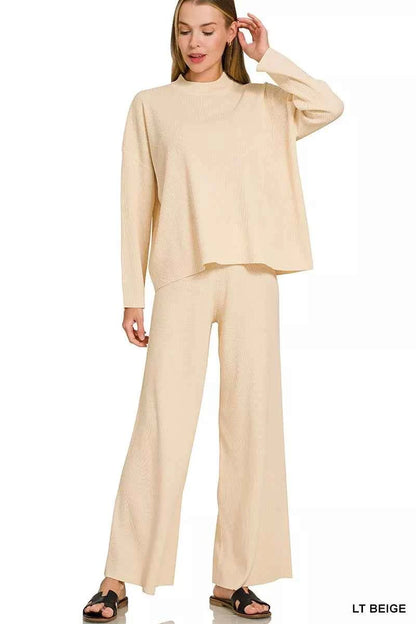 Woman wearing a light beige ribbed sweater and matching wide-leg pants set by Zenana featuring a relaxed fit and soft knit fabric. front view 2