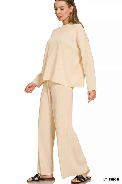 Woman wearing a light beige ribbed sweater and matching wide-leg pants set by Zenana featuring a relaxed fit and soft knit fabric. side view