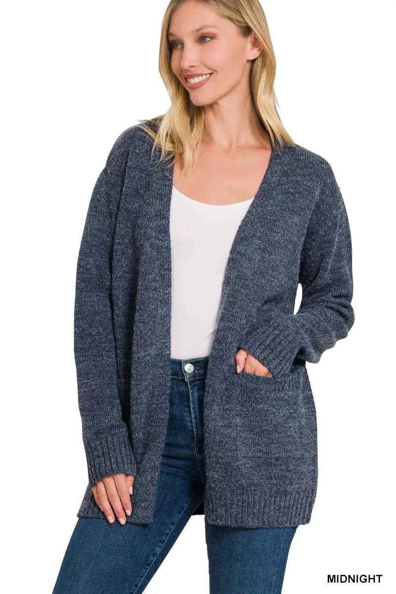 Woman wearing a midnight blue open-front knit cardigan with front pockets over a white tank and dark denim jeans by Zenana. Front View 2