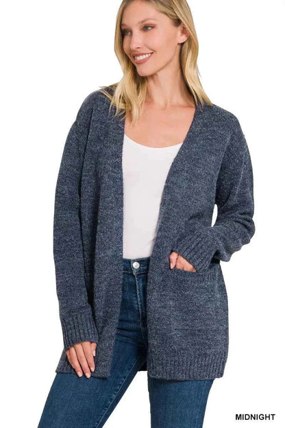 Woman wearing a midnight blue open-front knit cardigan with front pockets over a white tank and dark denim jeans by Zenana. Front View 2