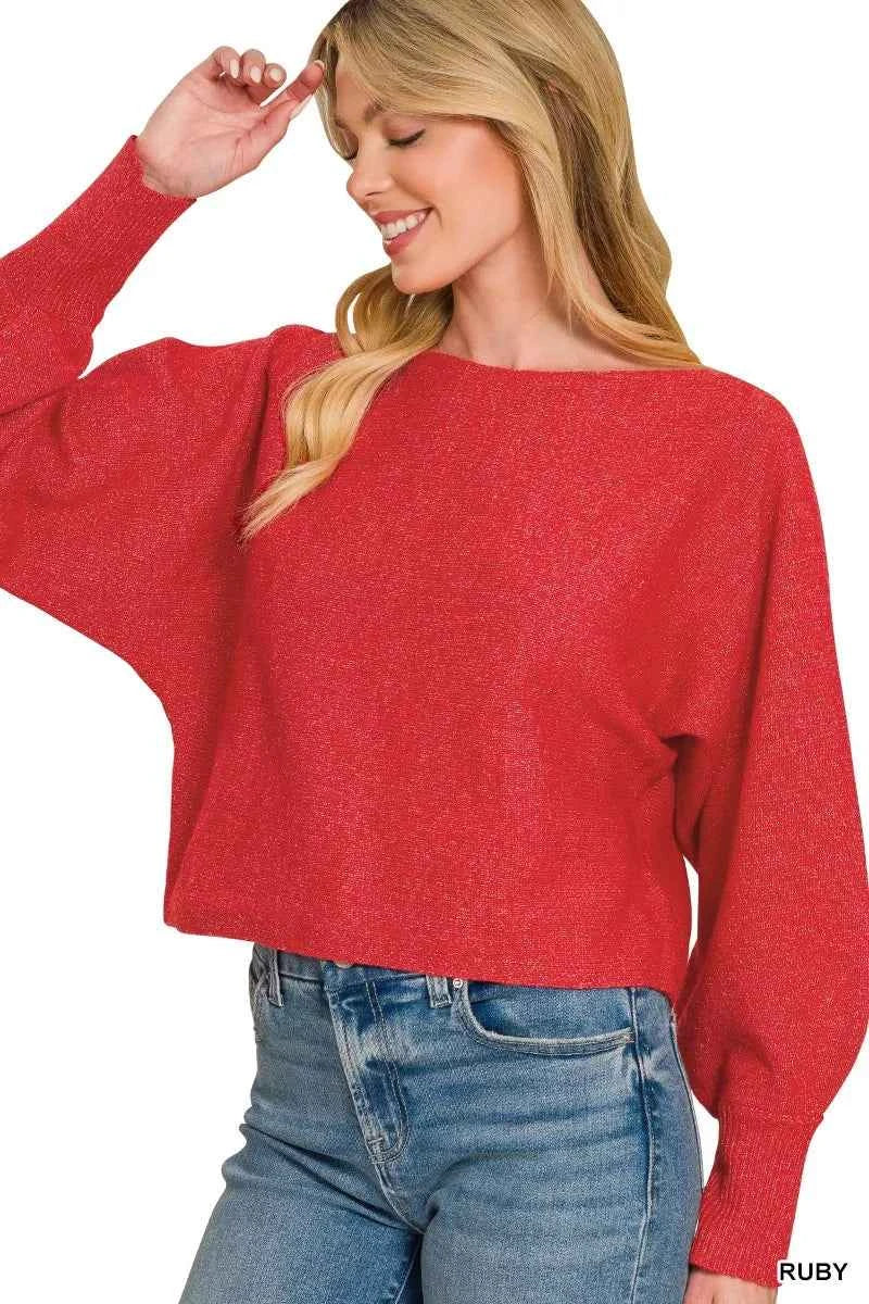Woman wearing a ruby red boat neck balloon sleeve knit sweater by Zenana with relaxed fit and ribbed cuffs. Side View