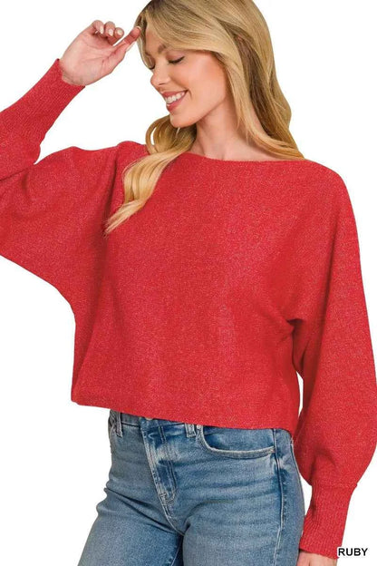 Woman wearing a ruby red boat neck balloon sleeve knit sweater by Zenana with relaxed fit and ribbed cuffs. Side View