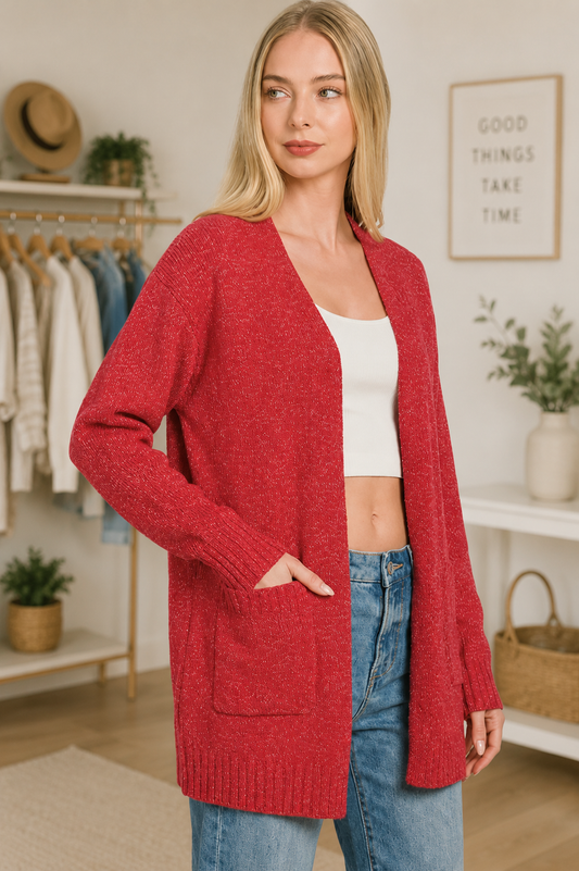 Woman wearing a ruby red open front knit cardigan sweater with front pockets by Zenana. Side View