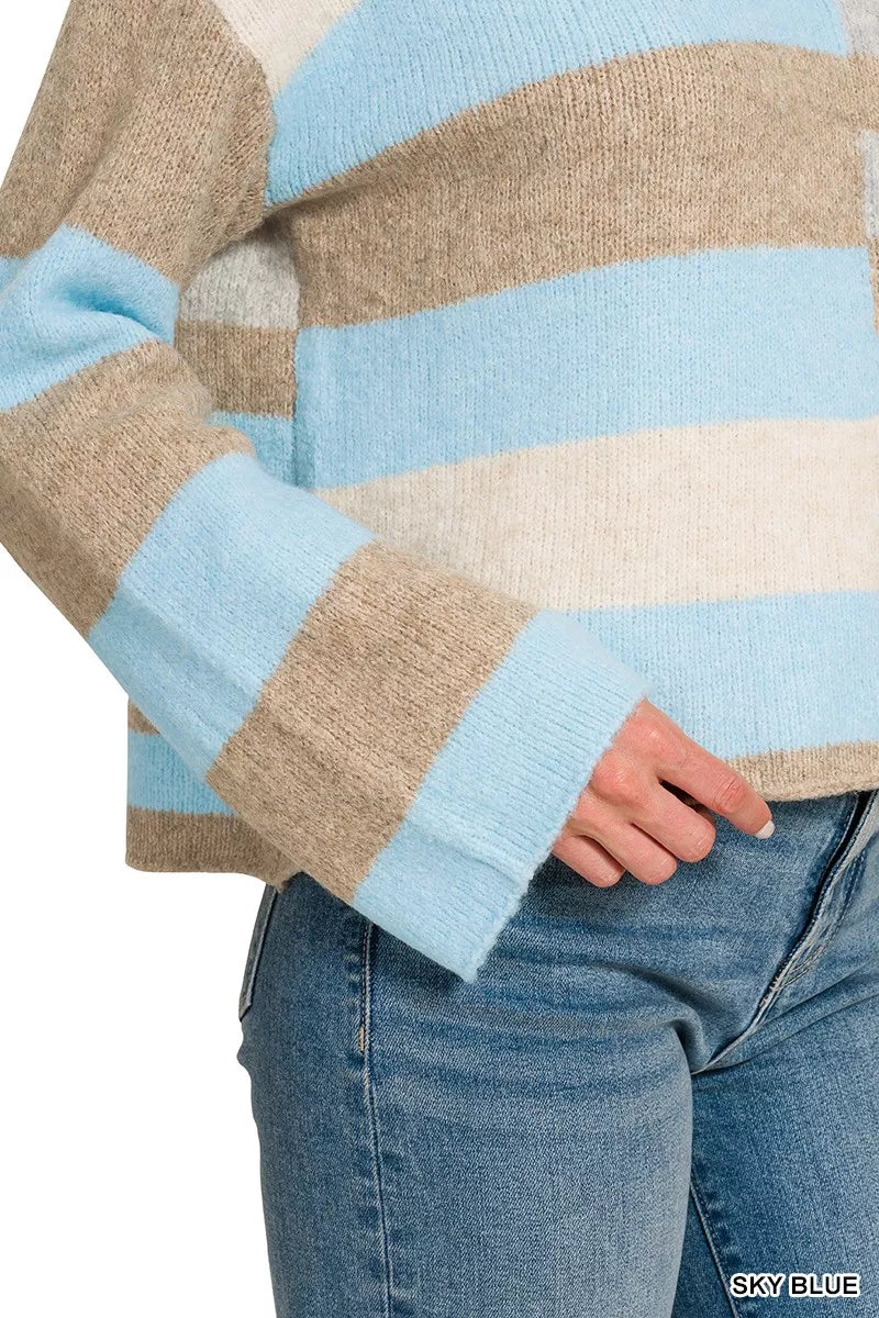 Woman wearing a sky blue, ivory, and oatmeal color block lightweight wool blend sweater by Zenana paired with blue jeans. Close View 2