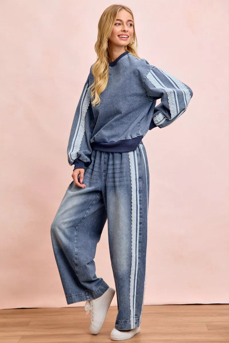 Woman wearing a washed denim lace contrast sweatshirt with long sleeves and relaxed fit by BiBi. Full View