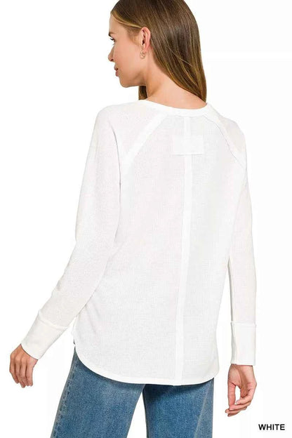 Woman wearing a white baby waffle knit long sleeve top by Zenana featuring raglan sleeves, a curved hem, and a relaxed everyday fit. Back View