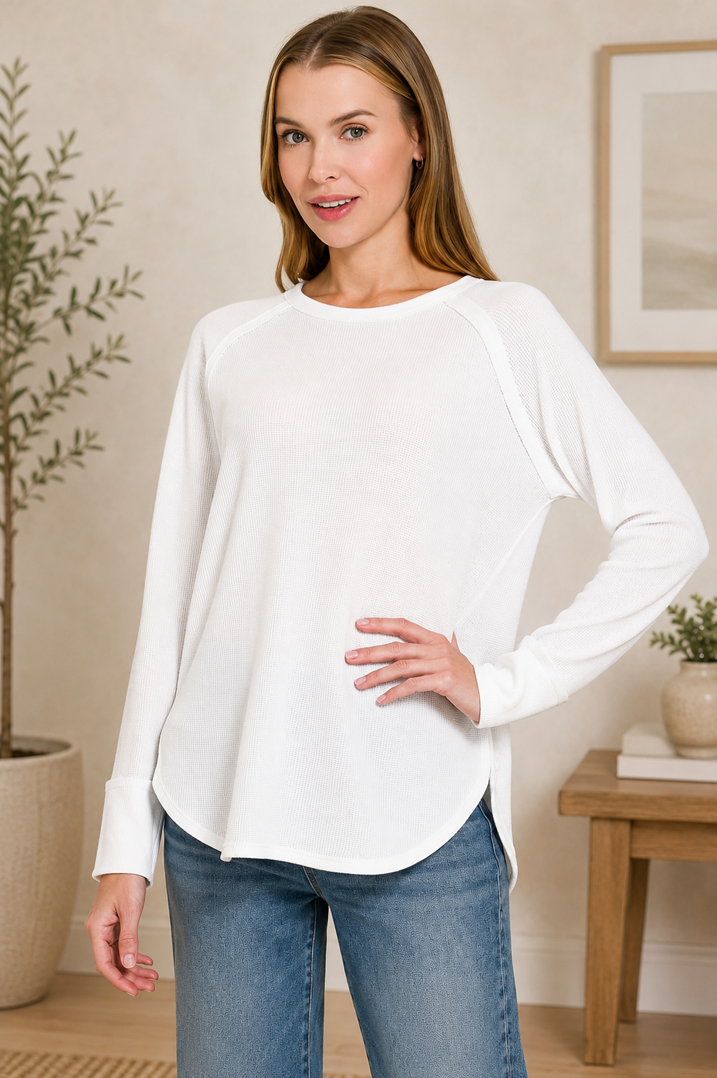 Woman wearing a white baby waffle knit long sleeve top by Zenana featuring raglan sleeves, a curved hem, and a relaxed everyday fit. Front view