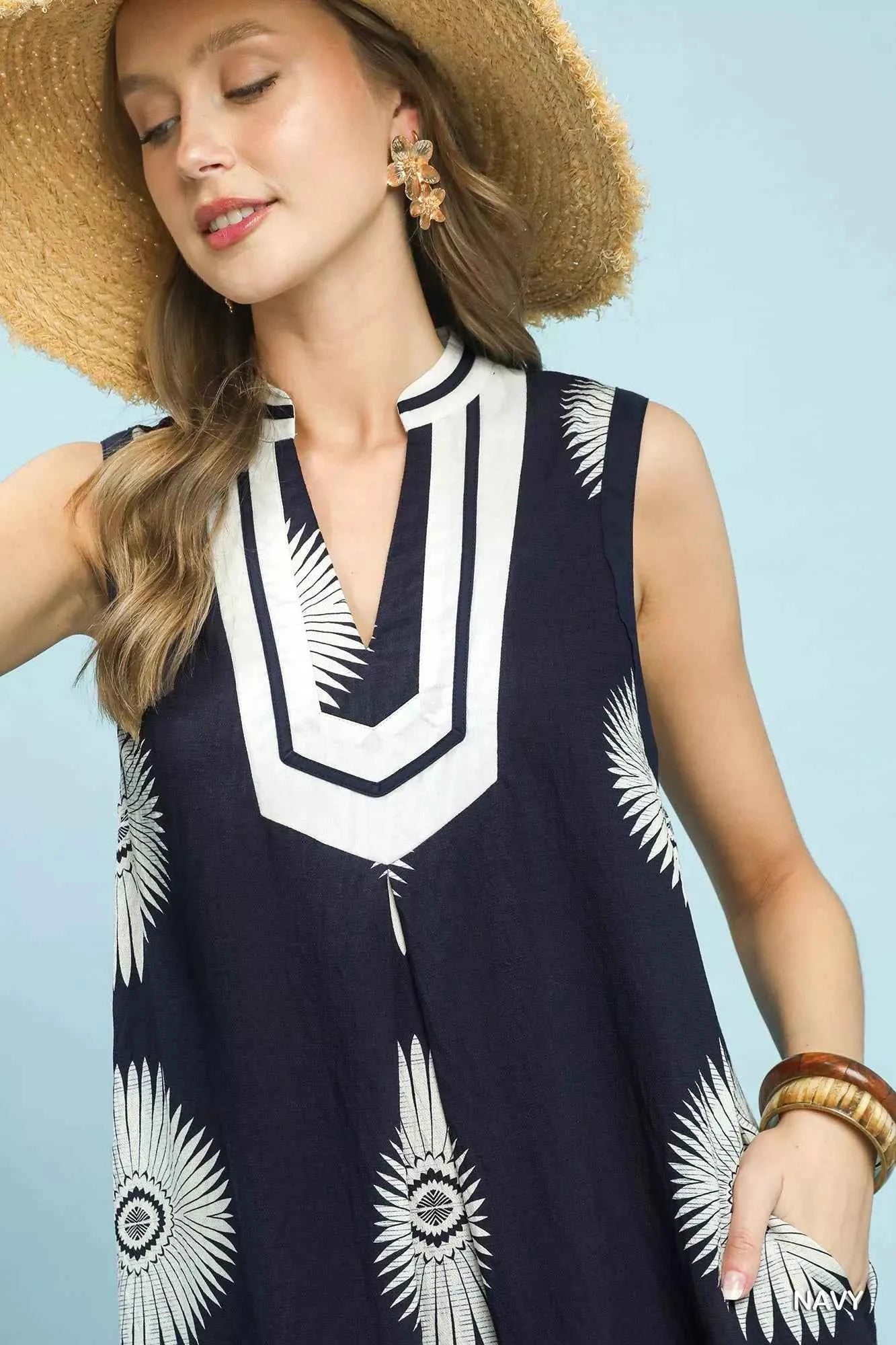 Woman wearing an Ocean Blue mixed floral and stripe print cotton dress with a split V-neckline and contrast trim by Umgee. Close View