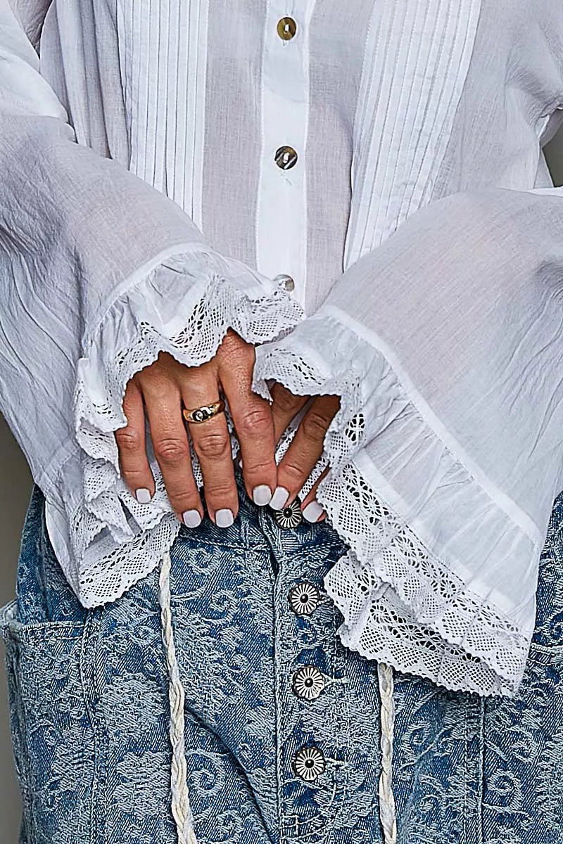 Woman wearing an ivory lace trim pintuck button-down blouse from POL, featuring romantic lace details, pleated front accents, and a relaxed fit. close view