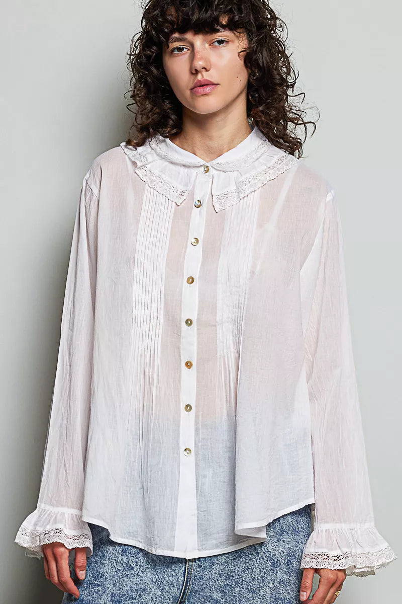 Woman wearing an ivory lace trim pintuck button-down blouse from POL, featuring romantic lace details, pleated front accents, and a relaxed fit. Front view 2