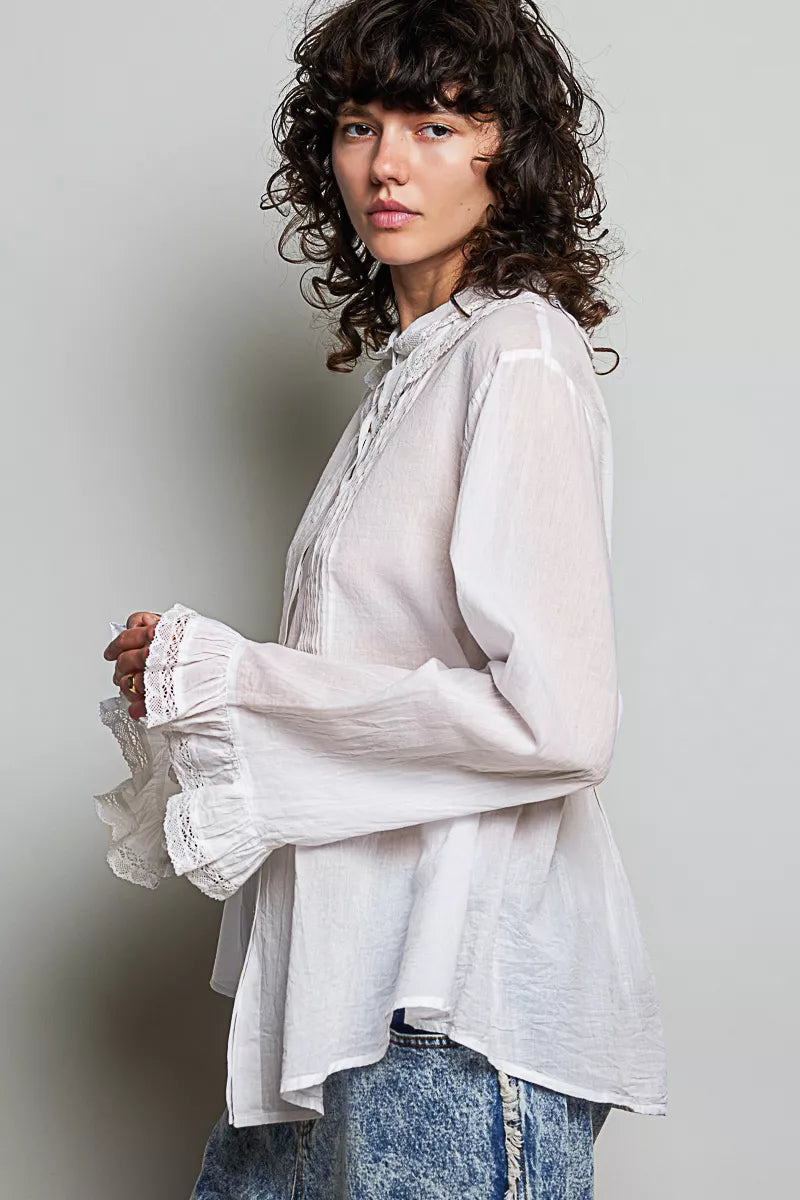 Woman wearing an ivory lace trim pintuck button-down blouse from POL, featuring romantic lace details, pleated front accents, and a relaxed fit. Side View 2