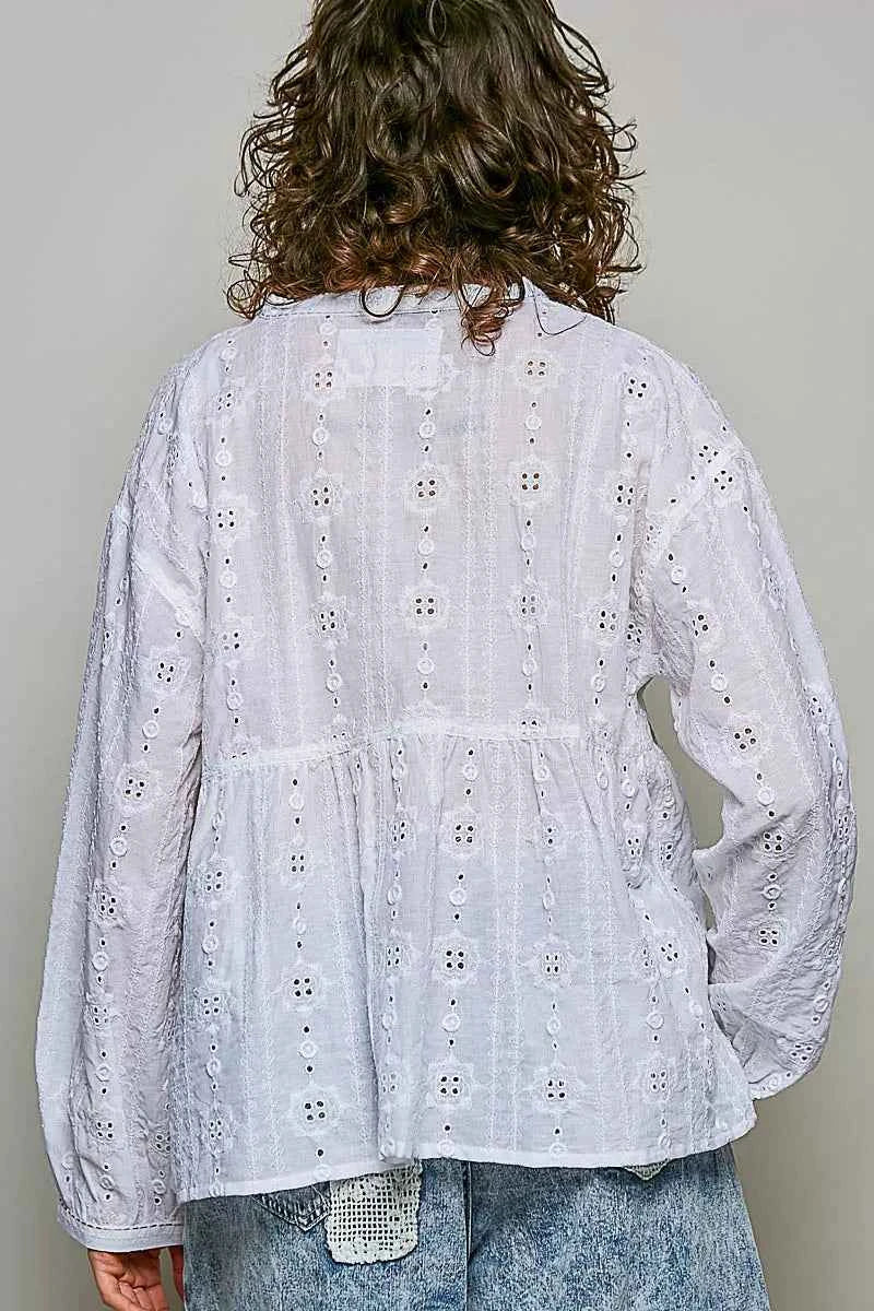 Woman wearing an off white POL cotton blouse with eyelet embroidery, lace detailing, and a split neckline.
 Back View