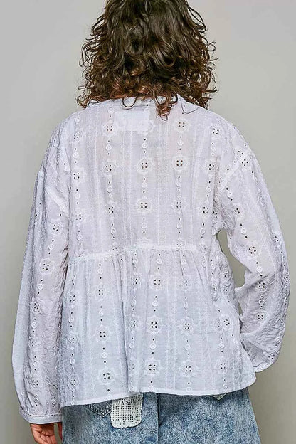 Woman wearing an off white POL cotton blouse with eyelet embroidery, lace detailing, and a split neckline.
 Back View