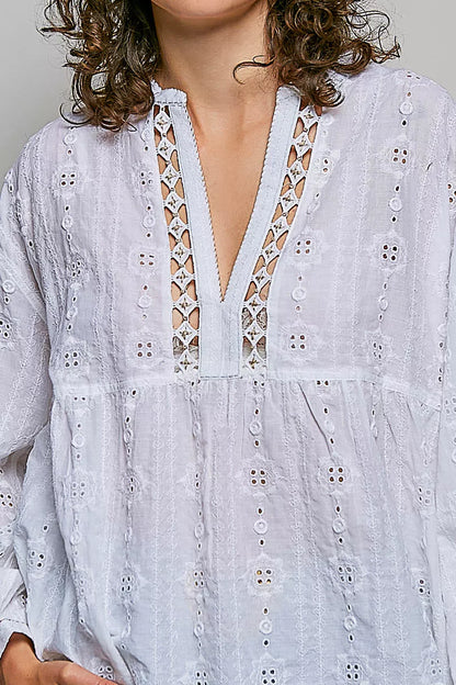 Woman wearing an off white POL cotton blouse with eyelet embroidery, lace detailing, and a split neckline.
 Close View