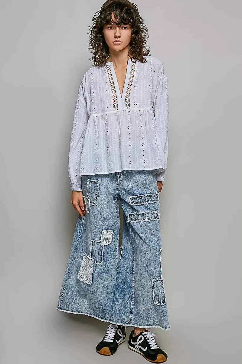 Woman wearing an off white POL cotton blouse with eyelet embroidery, lace detailing, and a split neckline.
 Full View