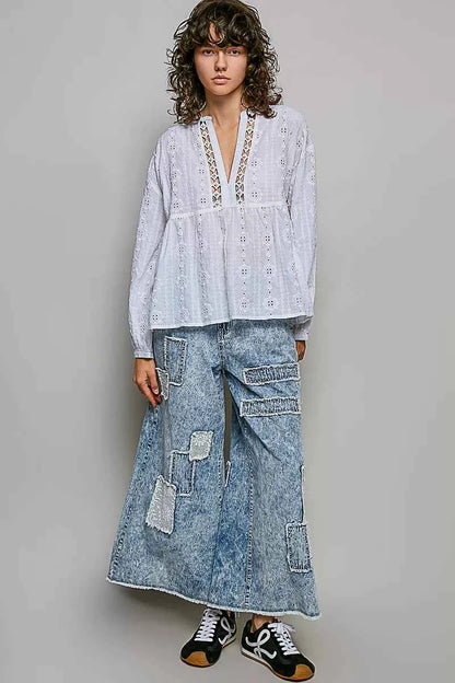 Woman wearing an off white POL cotton blouse with eyelet embroidery, lace detailing, and a split neckline.
 Full View