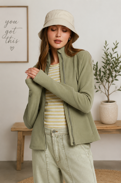 Woman wearing an olive soft fleece full zip jacket with side pockets by Umgee. Front View