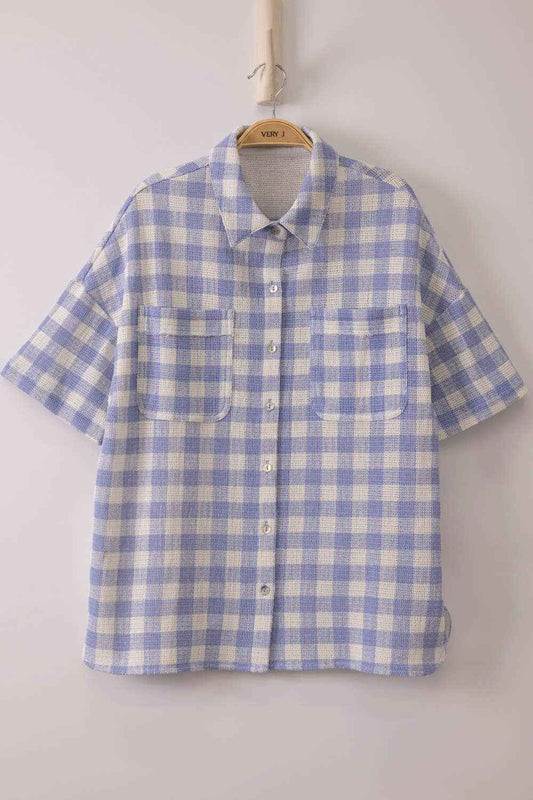 Woman wearing an oversized checkered button-down woven shirt with patch pockets and short sleeves front view from VERY J in blue