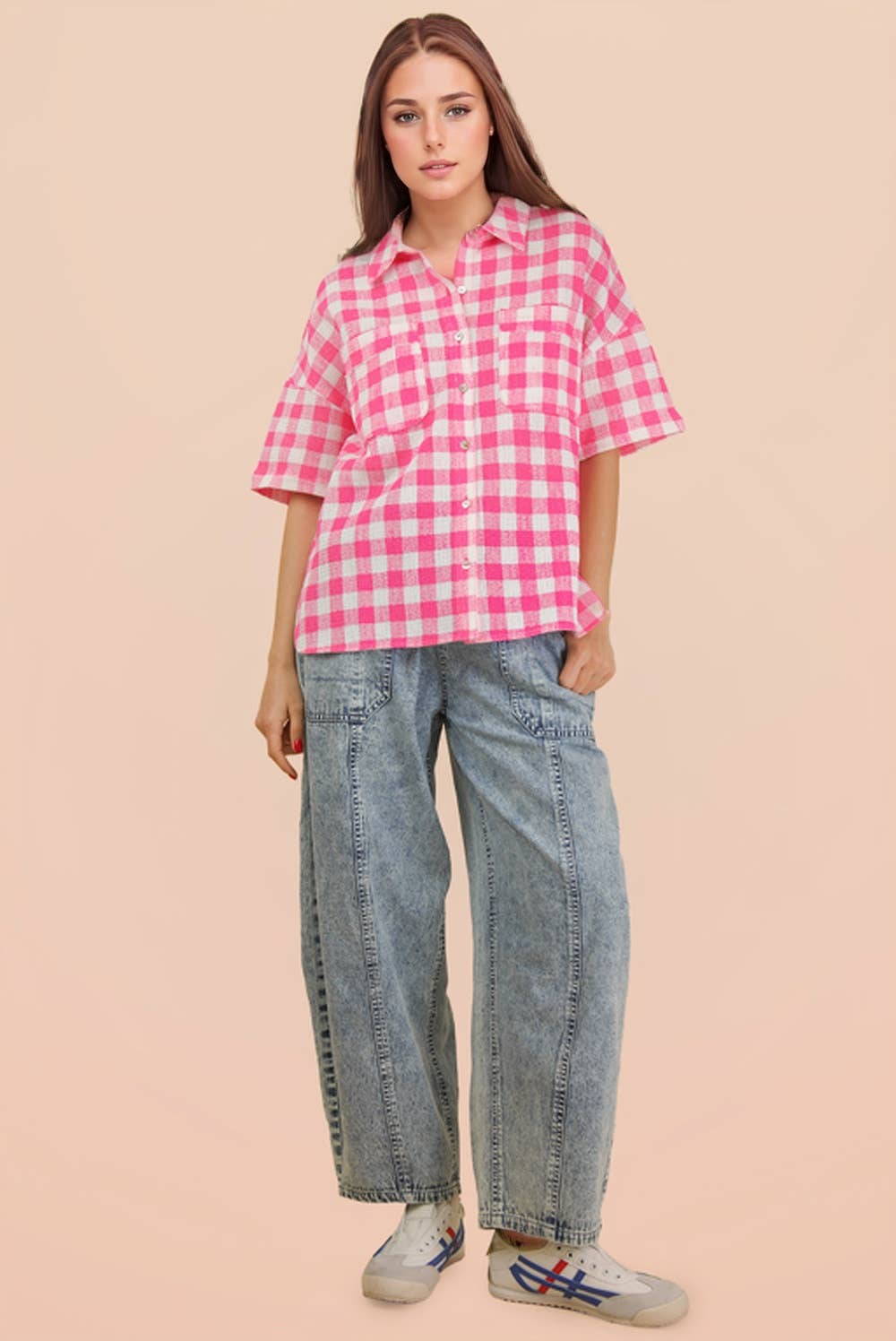 Woman wearing an oversized checkered button-down woven shirt with patch pockets and short sleeves front view from VERY J in pink full view