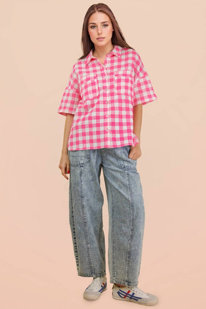 Woman wearing an oversized checkered button-down woven shirt with patch pockets and short sleeves front view from VERY J in pink full view