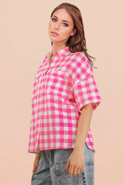Woman wearing an oversized checkered button-down woven shirt with patch pockets and short sleeves front view from VERY J in pink side view