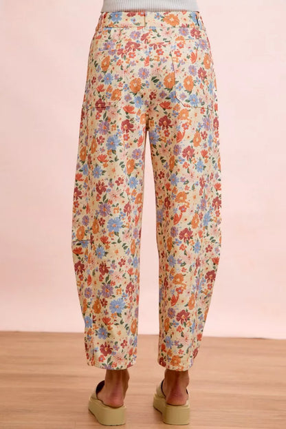 Woman wearing cream floral printed barrel-leg pants by BiBi with cream platform sandals. Back View