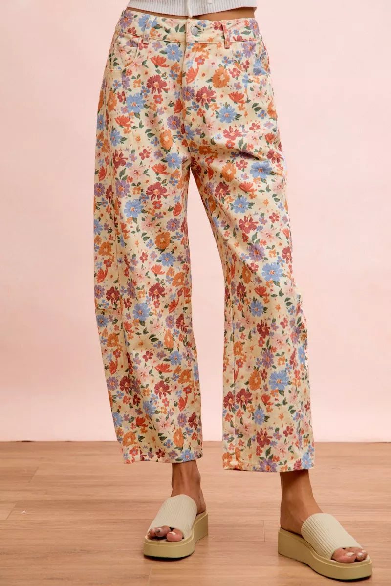 Woman wearing cream floral printed barrel-leg pants by BiBi with cream platform sandals. Front View