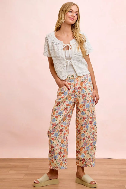 Woman wearing cream floral printed barrel-leg pants by BiBi with cream platform sandals. Full View