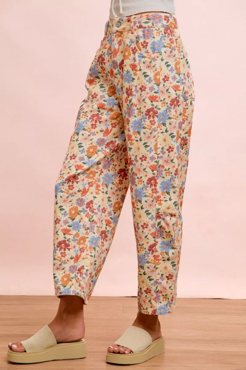 Woman wearing cream floral printed barrel-leg pants by BiBi with cream platform sandals. Side View